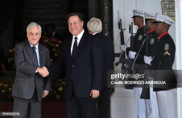 Panama's President Juan Carlos Varela and his Chilean counterpart Sebastian Pinera wave before a meeting at the presidential palace in Panama City,...