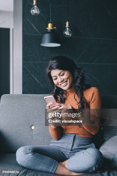 portrait of woman using her smartphone. - asian woman on call stock pictures, royalty-free photos & images