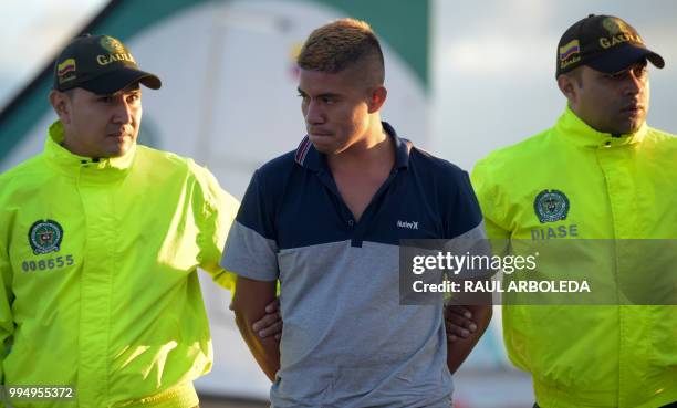 Colombian police escort Jesus Vargas, aka "Reinel", who was allegedly in charge of guarding the members of the news team from Ecuadorean newspaper El...