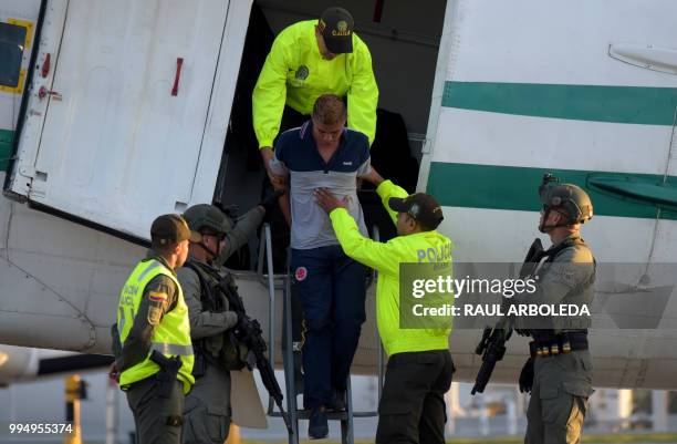 Colombian police escort Jesus Vargas, aka "Reinel", who was allegedly in charge of guarding the members of the news team from Ecuadorean newspaper El...