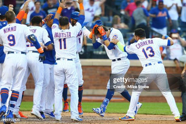 Wilmer Flores of the New York Mets celebrates after hitting a game-winning, walk-off home run in the 10th inning against the Philadelphia Phillies...