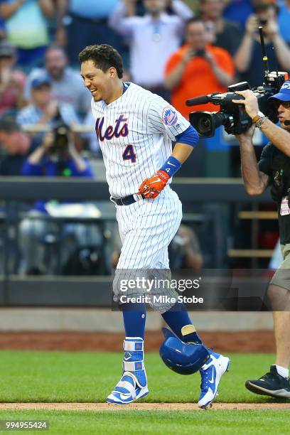 Wilmer Flores of the New York Mets celebrates after hitting a game-winning, walk-off home run in the 10th inning against the Philadelphia Phillies...