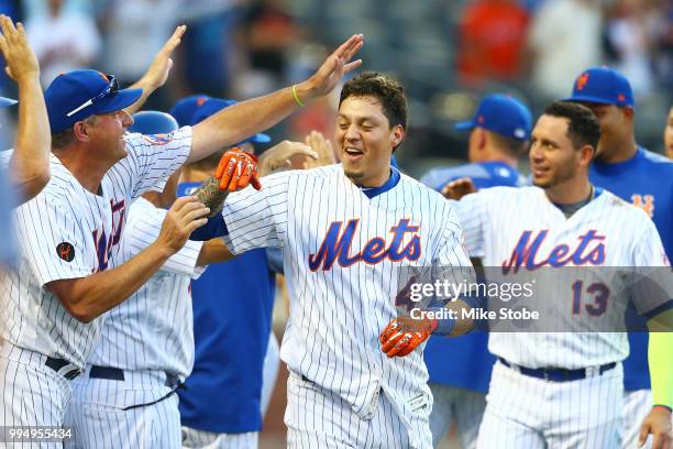 Wilmer Flores of the New York Mets celebrates after hitting a game-winning, walk-off home run in the 10th inning against the Philadelphia Phillies...