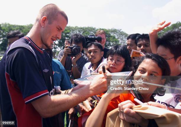 David Beckham of Manchester United signs autographs for Fans after a Training Session at the Fam Training Ground in Petaling Jaya, Malaysia during...