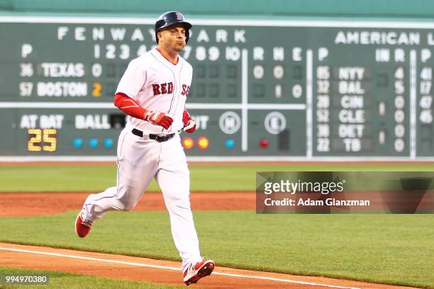 Steve Pearce of the Boston Red Sox rounds the bases after hitting a two-run home run in the first inning of a game against the Texas Rangers at...