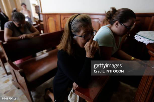 Women pray at the San Sebastian Basilica in Diriamba, Nicaragua, on July 9, 2018 after an invasion by members of the pro-government Sandinista...