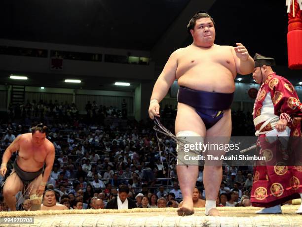 Onosho reacts after his victory against Mongolian wrestler Arawashi on day two of the Grand Sumo Nagoya Tournament at the Dolphin's Arena on July 9,...