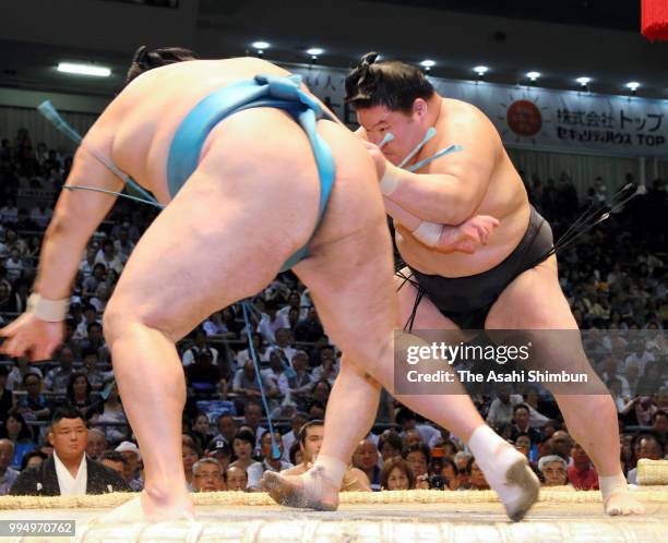 Ozeki Goeido pushes Mongolian komusubi Tamawashi out of the ring to win on day two of the Grand Sumo Nagoya Tournament at the Dolphin's Arena on July...