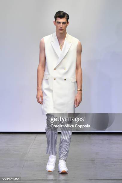 Model walks the runway at the Carlos Campos show - Runway - July 2018 New York City Men's Fashion Week at Industria Studios on July 9, 2018 in New...