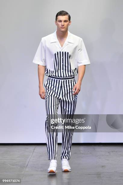 Model walks the runway at the Carlos Campos show - Runway - July 2018 New York City Men's Fashion Week at Industria Studios on July 9, 2018 in New...