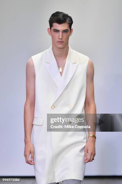 Model walks the runway at the Carlos Campos show - Runway - July 2018 New York City Men's Fashion Week at Industria Studios on July 9, 2018 in New...