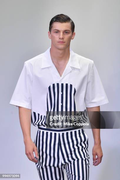 Model walks the runway at the Carlos Campos show - Runway - July 2018 New York City Men's Fashion Week at Industria Studios on July 9, 2018 in New...
