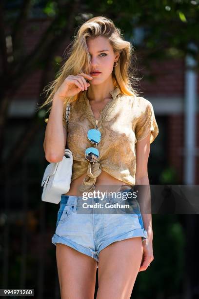 Joy Corrigan is seen wearing a Chasing Unicorns top, One Teaspoon jean shorts with Buffalo London sneakers in the Lower East Side on July 9, 2018 in...