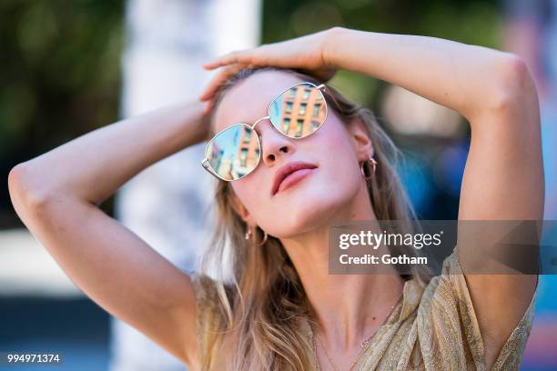 Joy Corrigan is seen wearing a Chasing Unicorns top, One Teaspoon jean shorts with Buffalo London sneakers in the Lower East Side on July 9, 2018 in...