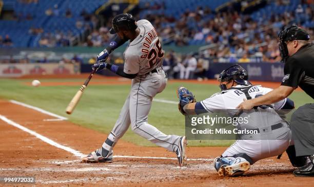 Niko Goodrum of the Detroit Tigers hits a two-RBI double in front of catcher Wilson Ramos of the Tampa Bay Rays in the third inning of a baseball...