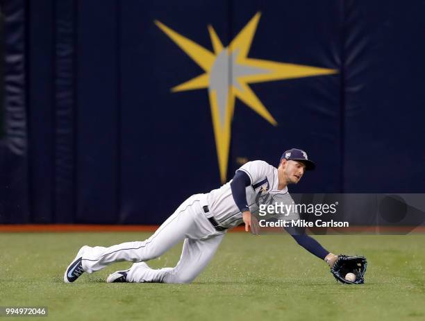 Daniel Robertson of the Tampa Bay Rays makes a diving catch on a fly ball from Mikie Mahtook of the Detroit Tigers in the third inning of a baseball...