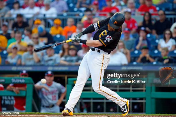 Colin Moran of the Pittsburgh Pirates hits a RBI single in the first inning against the Washington Nationals at PNC Park on July 9, 2018 in...