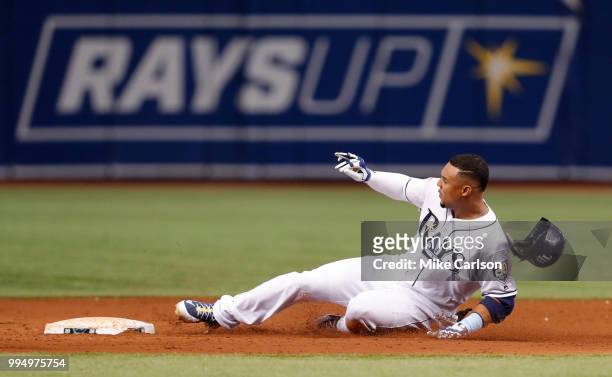 Carlos Gomez of the Tampa Bay Rays slides into second with a double in the third inning of a baseball game against the Detroit Tigers at Tropicana...
