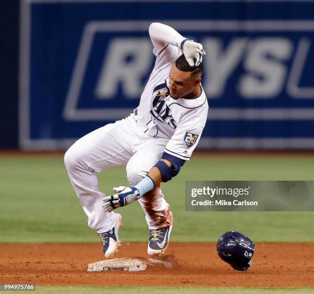 Carlos Gomez of the Tampa Bay Rays slides into second with a double in the third inning of a baseball game against the Detroit Tigers at Tropicana...