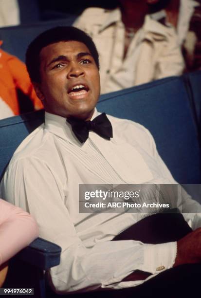 Muhammad Ali sitting ringside.
