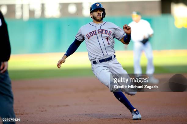 Carlos Correa of the Houston Astros slides safely into third during the game against the Oakland Athletics at the Oakland Alameda Coliseum on June...