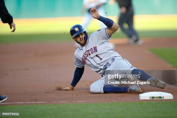 Carlos Correa of the Houston Astros slides safely into third during the game against the Oakland Athletics at the Oakland Alameda Coliseum on June...