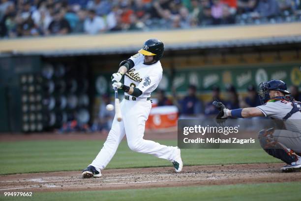 Jed Lowrie of the Oakland Athletics bats during the game against the Houston Astros at the Oakland Alameda Coliseum on June 13, 2018 in Oakland,...