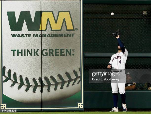 George Springer of the Houston Astros makes a catch on a pop fly by Mark Canha of the Oakland Athletics in the fourth inning \ at Minute Maid Park on...