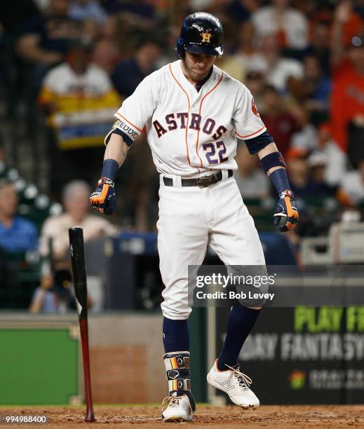 Josh Reddick of the Houston Astros slams his bat down after striking out in the fourth inning against the Oakland Athletics at Minute Maid Park on...