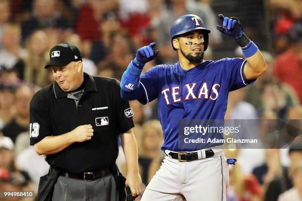 Robinson Chirinos of the Texas Rangers reacts after hitting a triple in the seventh inning of a game against the Boston Red Sox at Fenway Park on...