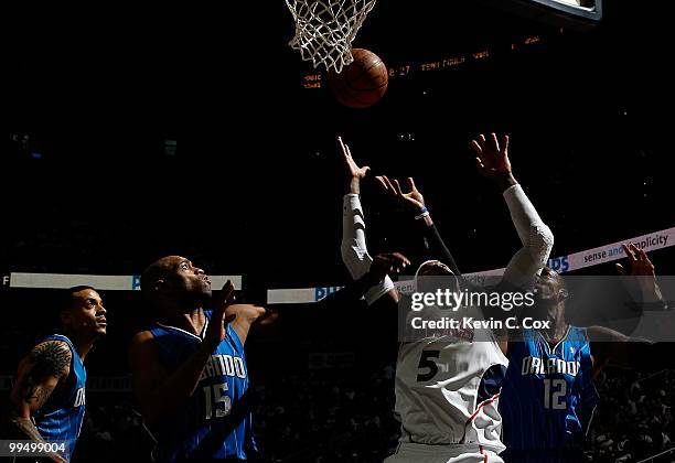Matt Barnes, Vince Carter and Dwight Howard of the Orlando Magic against Josh Smith of the Atlanta Hawks during Game Three of the Eastern Conference...