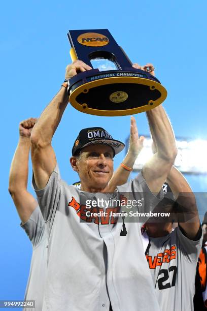 Head Coach Pat Casey of the Oregon State Beavers receives the national championship trophy after defeating the Arkansas Razorbacks during the...