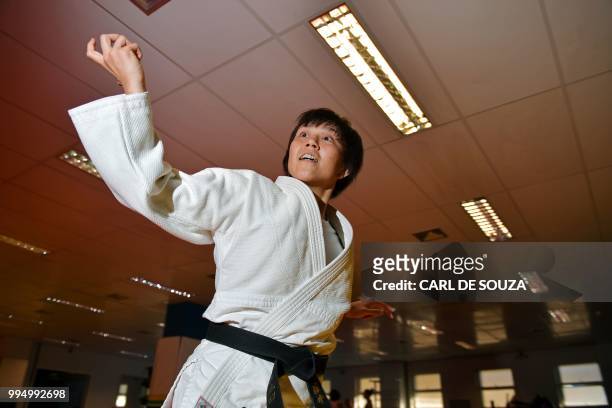 Japanese 35-year-old black belt Yuko Fujii, head coach of the Brazilian men's national team, warms up before giving a class in Rio de Janeiro,...