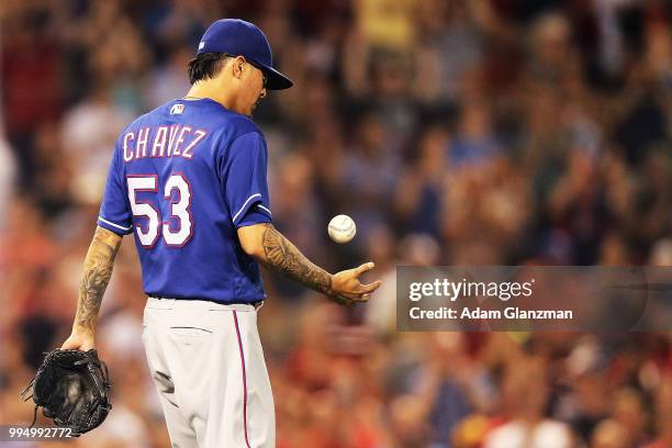 Jesse Chavez of the Texas Rangers reacts after giving up a three-run home run to J.D. Martinez of the Boston Red Sox in the eighth inning of a game...