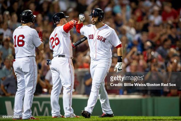 Martinez of the Boston Red Sox reacts with Steve Pearce and Andrew Benintendi after hitting a three-run home run during the eighth inning of a game...