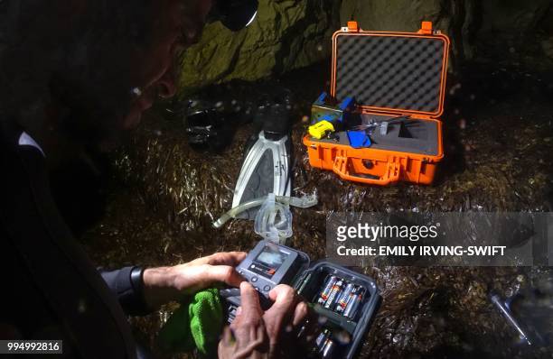 Savvas from the Cypriot department of fisheries and marine research checks the images on a camera installed in a cave to record the activity of the...