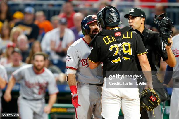 Adam Eaton of the Washington Nationals and Francisco Cervelli of the Pittsburgh Pirates have words in the sixth inning at PNC Park on July 9, 2018 in...