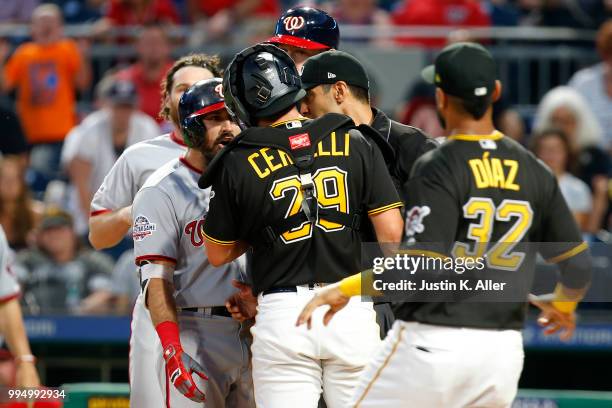 Adam Eaton of the Washington Nationals and Francisco Cervelli of the Pittsburgh Pirates have words in the sixth inning at PNC Park on July 9, 2018 in...