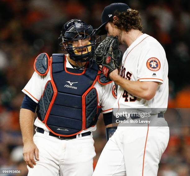 Gerrit Cole of the Houston Astros talks with Tim Federowicz at Minute Maid Park on July 9, 2018 in Houston, Texas.