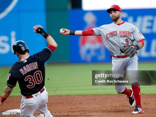 Jose Peraza of the Cincinnati Reds forces out Tyler Naquin of the Cleveland Indians at second base and throws out Greg Allen at first base to...