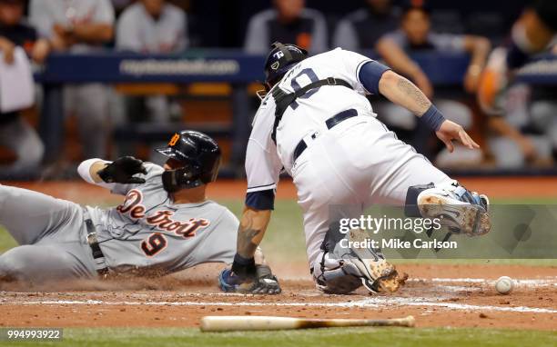 Nicholas Castellanos of the Detroit Tigers scores after Wilson Ramos of the Tampa Bay Rays does not have the ball when applying the tag in the...