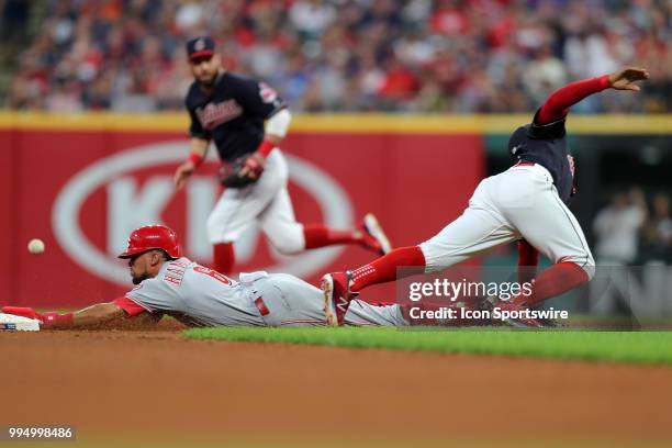 Cincinnati Reds center fielder Billy Hamilton is safe at second with a stolen base as the throw from Cleveland Indians catcher Yan Gomes gets past...