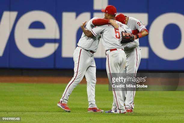 Nick Williams, Aaron Altherr and Rhys Hoskins of the Philadelphia Phillies celebrate after defeating the New York Mets 3-1 during game two of a...
