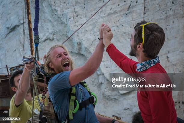 Members of the rope jump french team Pyrenaline jumped from atop the rugged rocks overlooking the azure waters, Ionian Islands, Zakynthos, Greece.
