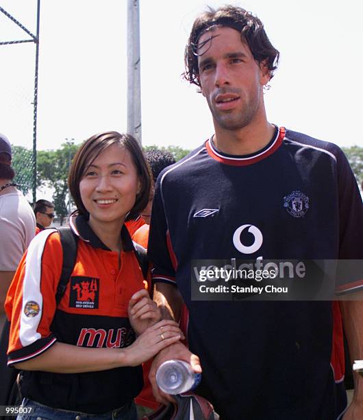 Manchester United Fan poses for photograph with Dutch Star Ruud Van Nistelrooy during Manchester United's Training Session at the Fam Training Ground...
