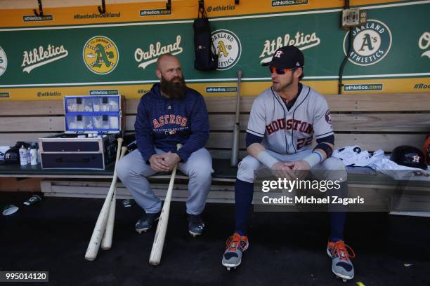 Evan Gattis and Josh Reddick of the Houston Astros st in the dugout prior to the game against the Oakland Athletics at the Oakland Alameda Coliseum...