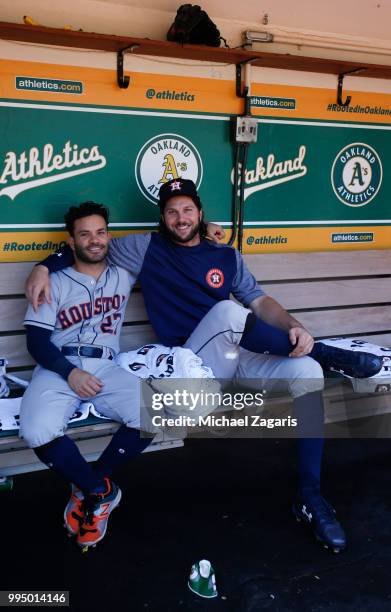 Jose Altuve and Jake Marisnick of the Houston Astros relax in the dugout prior to the game against the Oakland Athletics at the Oakland Alameda...