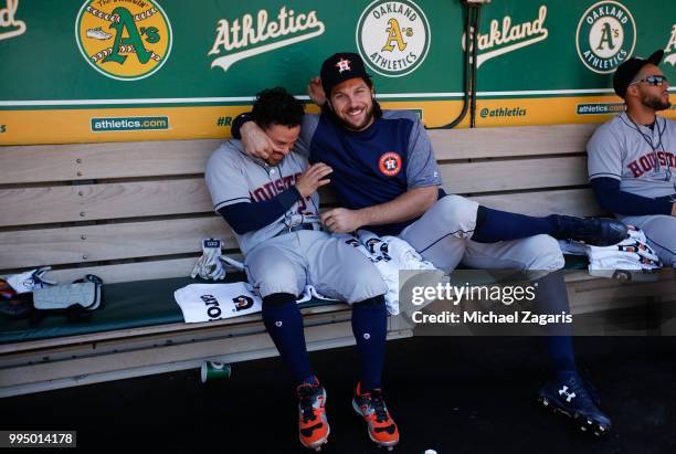 Jose Altuve and Jake Marisnick of the Houston Astros relax in the dugout prior to the game against the Oakland Athletics at the Oakland Alameda...