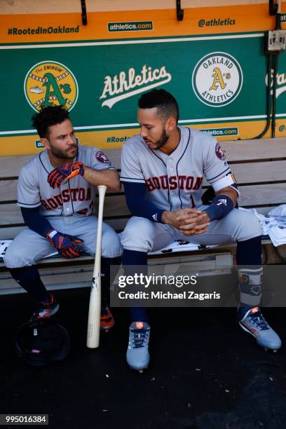 Jose Altuve and Carlos Correa of the Houston Astros talk in the dugout prior to the game against the Oakland Athletics at the Oakland Alameda...