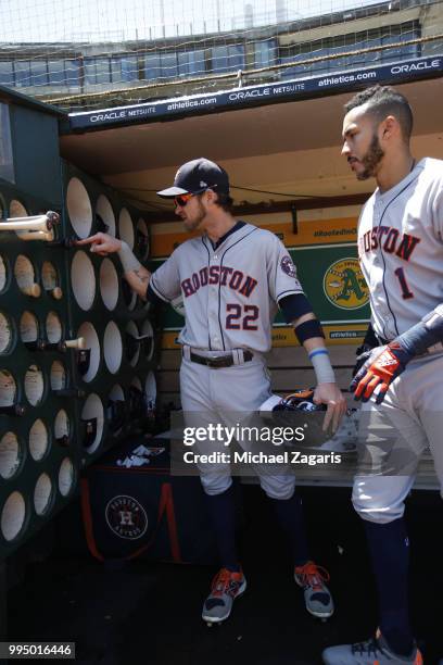 Josh Reddick and Carlos Correa of the Houston Astros stand in the dugout prior to the game against the Oakland Athletics at the Oakland Alameda...